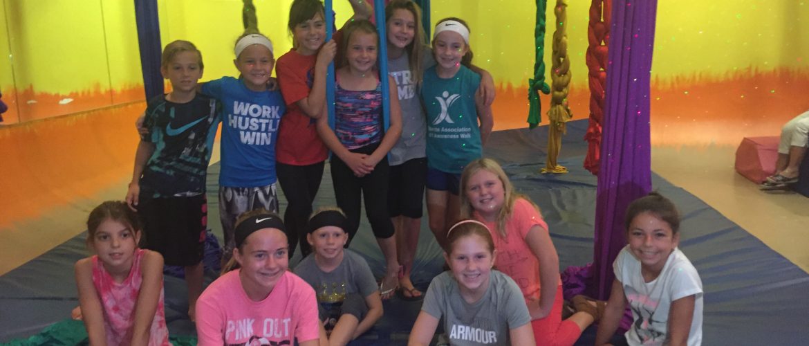 kids sitting around the silks at a birthday party